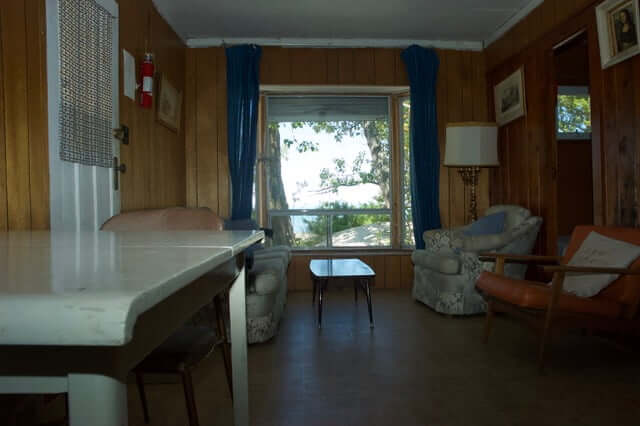 Chairs and lamp with big window facing beach